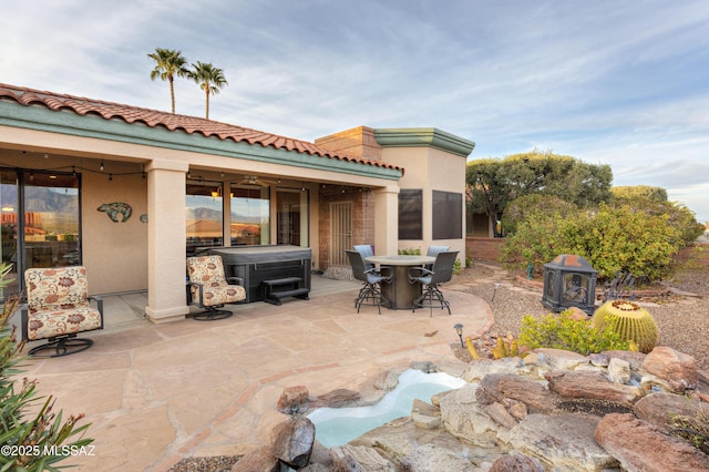 view of patio / terrace with a hot tub