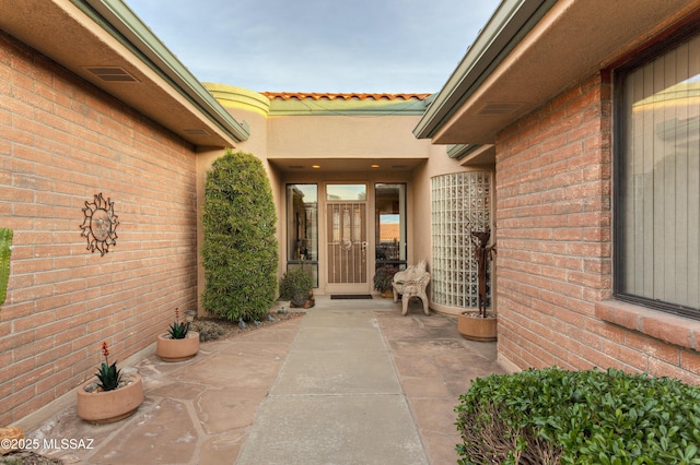 property entrance featuring a patio area