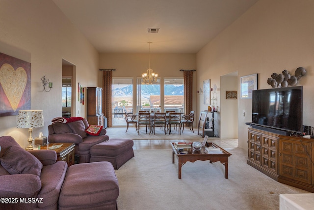 carpeted living room featuring a chandelier