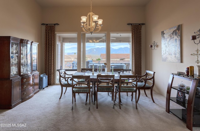 dining area with light carpet and an inviting chandelier