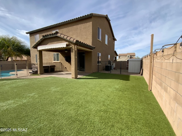 rear view of house with a fenced in pool, a lawn, central AC unit, and a patio area