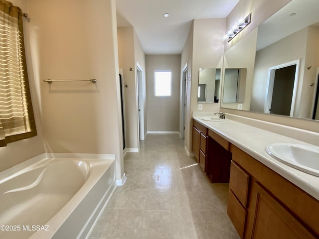 bathroom featuring vanity and a tub to relax in