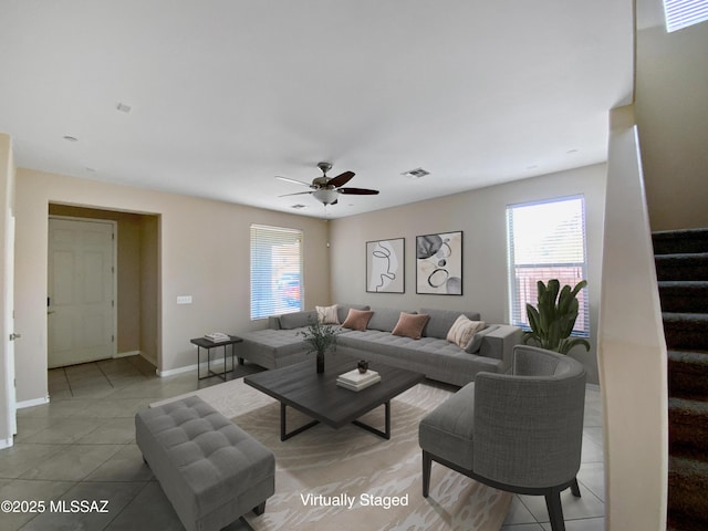 living room featuring ceiling fan and tile patterned floors