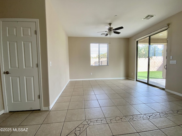 spare room with light tile patterned floors and ceiling fan