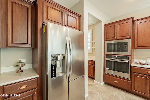 kitchen with light tile patterned floors and appliances with stainless steel finishes