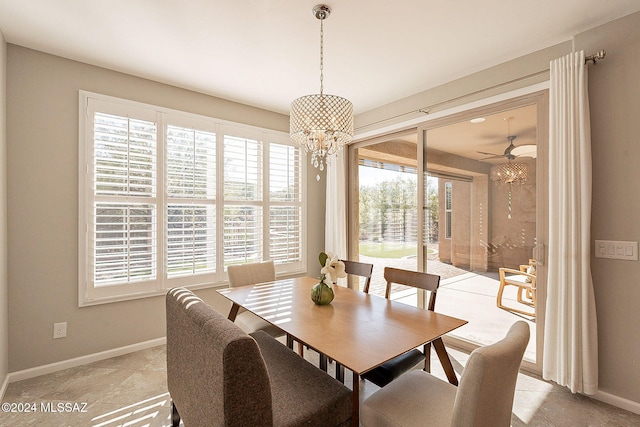 dining room with plenty of natural light and ceiling fan with notable chandelier