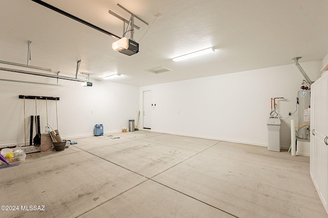 garage featuring a garage door opener and gas water heater