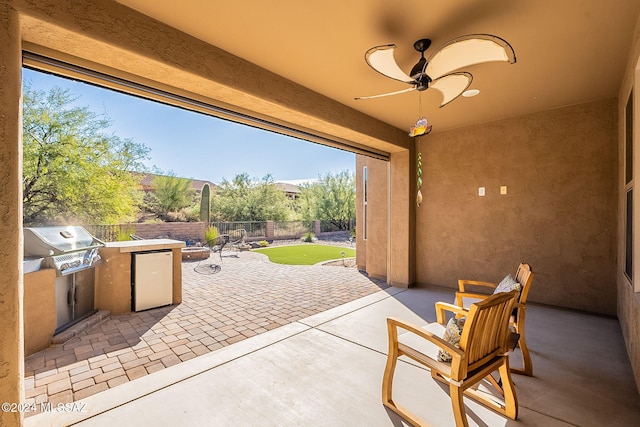 view of patio / terrace with area for grilling and ceiling fan