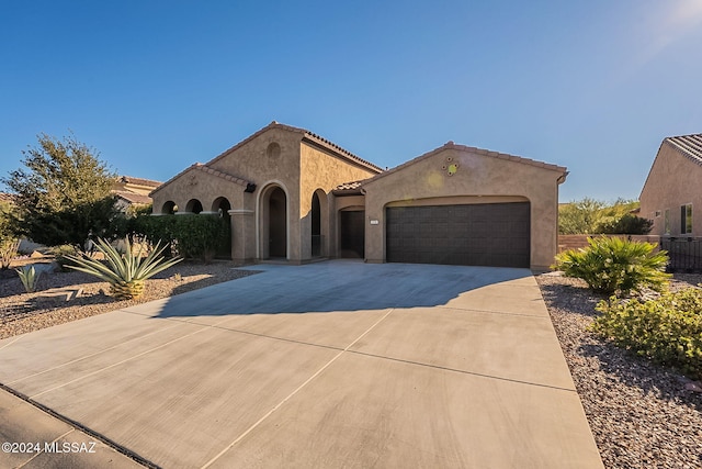 mediterranean / spanish house with a garage