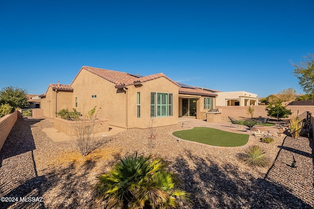 back of property featuring a patio