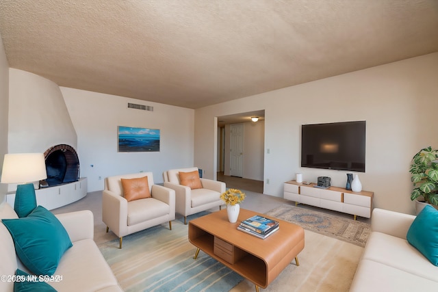 living room featuring visible vents and a textured ceiling