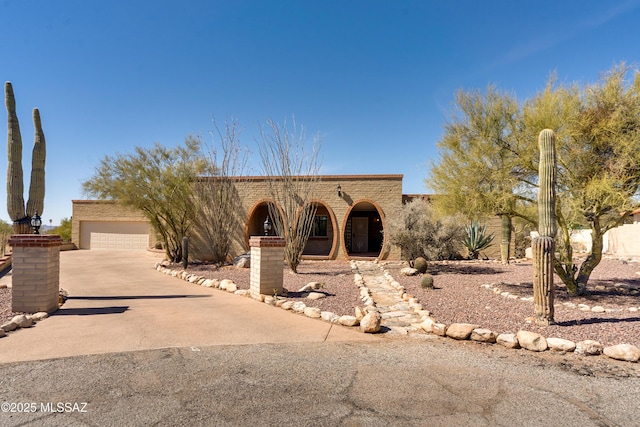 pueblo-style house with a detached garage