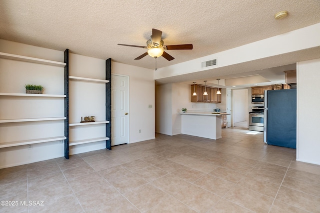 unfurnished living room featuring a ceiling fan, visible vents, and a textured ceiling