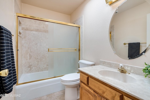 bathroom with toilet, shower / bath combination with glass door, tile patterned floors, and vanity