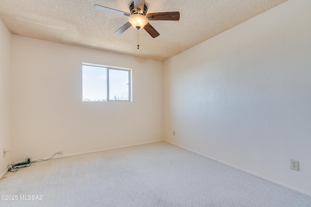 unfurnished room featuring a textured ceiling, a ceiling fan, and baseboards