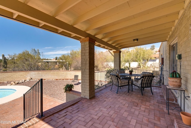 view of patio with outdoor dining area and a fenced backyard