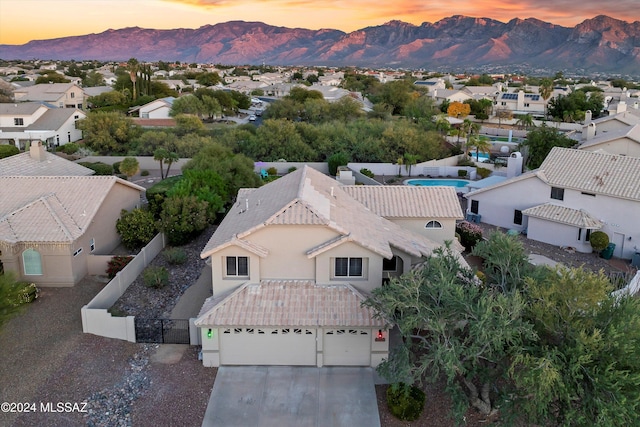 aerial view at dusk featuring a mountain view