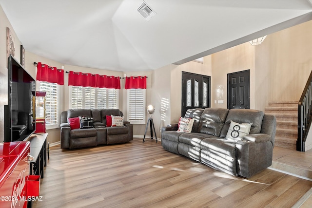 living room featuring light hardwood / wood-style flooring and lofted ceiling