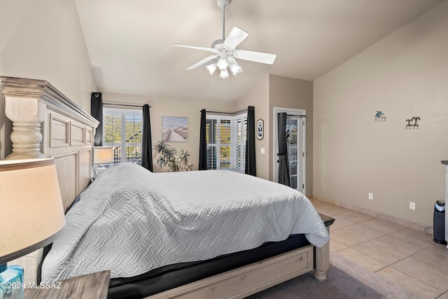 bedroom featuring ceiling fan, light tile patterned floors, and lofted ceiling