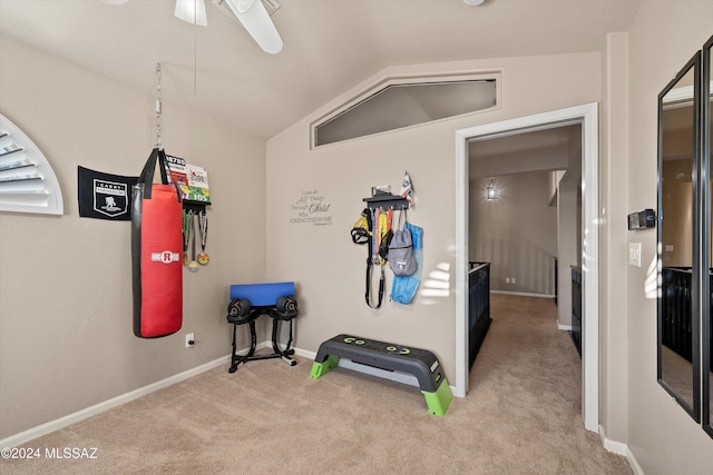 exercise room with light colored carpet, ceiling fan, and lofted ceiling