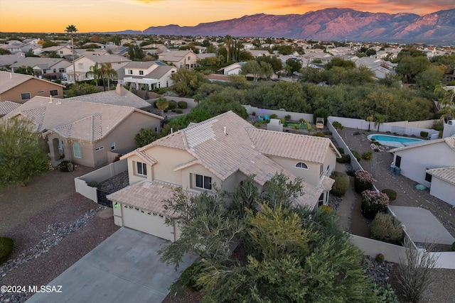 aerial view at dusk featuring a mountain view