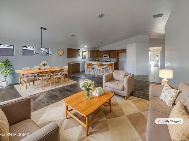 living room featuring light hardwood / wood-style floors and lofted ceiling