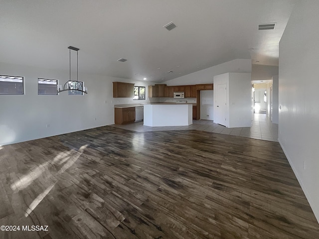 unfurnished living room featuring dark hardwood / wood-style floors and vaulted ceiling