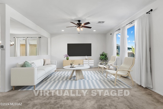 living room with ceiling fan and light carpet