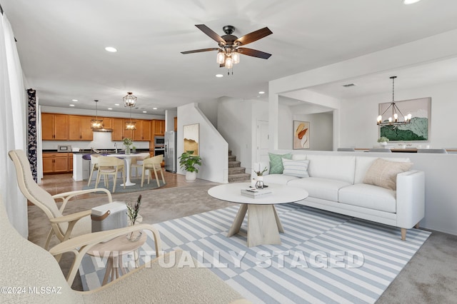 living room with light colored carpet and ceiling fan with notable chandelier