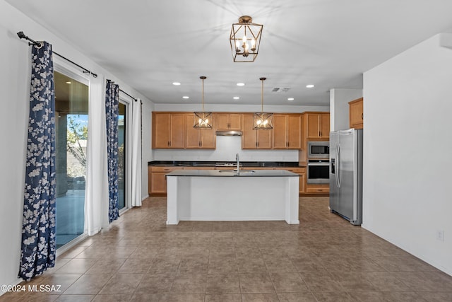 kitchen featuring sink, hanging light fixtures, stainless steel appliances, a kitchen island with sink, and light tile patterned floors