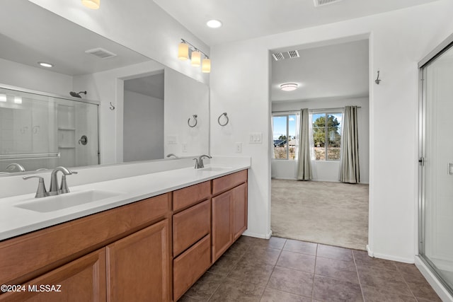 bathroom with vanity, tile patterned floors, and walk in shower