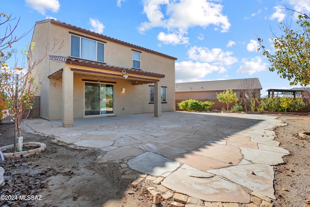 back of property featuring a patio