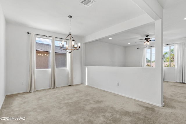 unfurnished room featuring plenty of natural light, light colored carpet, and ceiling fan with notable chandelier