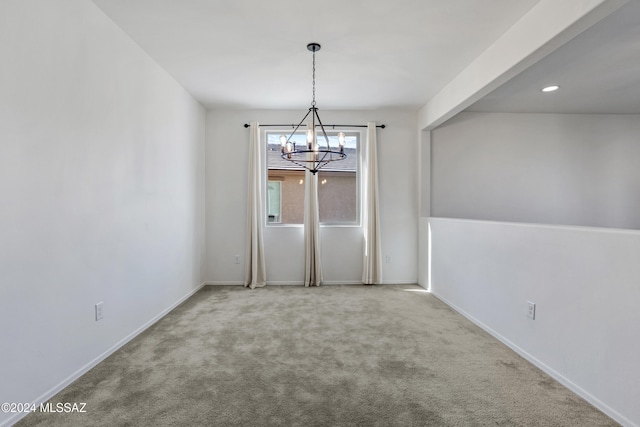 unfurnished dining area featuring carpet floors and a notable chandelier