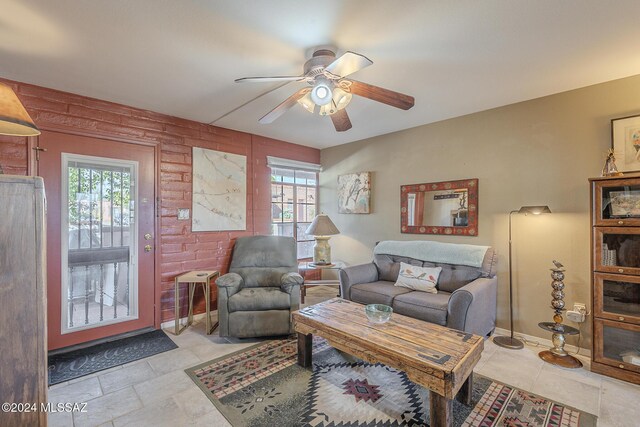 living room featuring ceiling fan and plenty of natural light