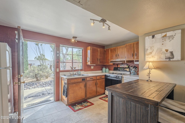 kitchen featuring white appliances and sink