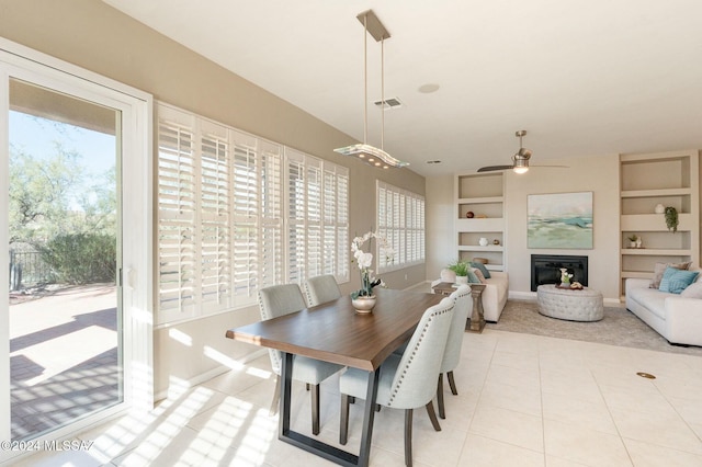 dining space with built in shelves, light tile patterned floors, plenty of natural light, and ceiling fan