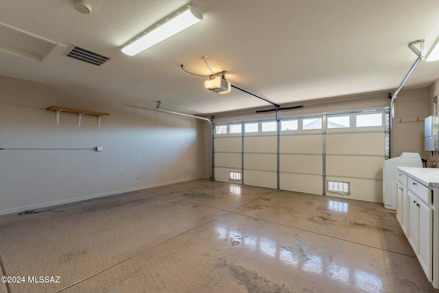 garage featuring washer / clothes dryer and a garage door opener