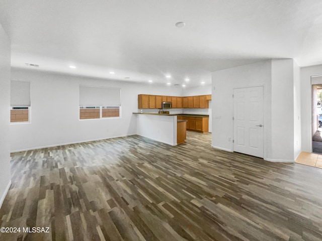 unfurnished living room featuring dark hardwood / wood-style flooring