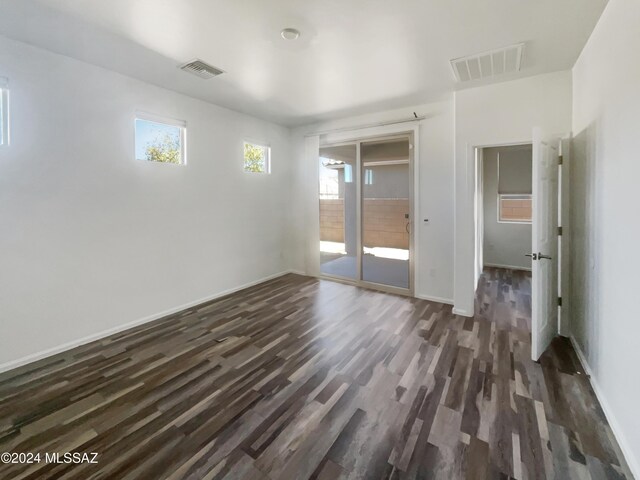 spare room featuring dark wood-type flooring