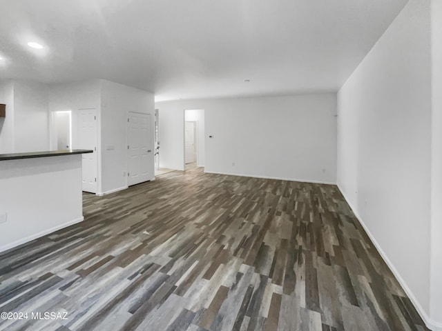 unfurnished living room featuring dark hardwood / wood-style flooring