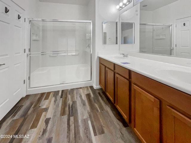 bathroom featuring vanity, hardwood / wood-style flooring, and walk in shower