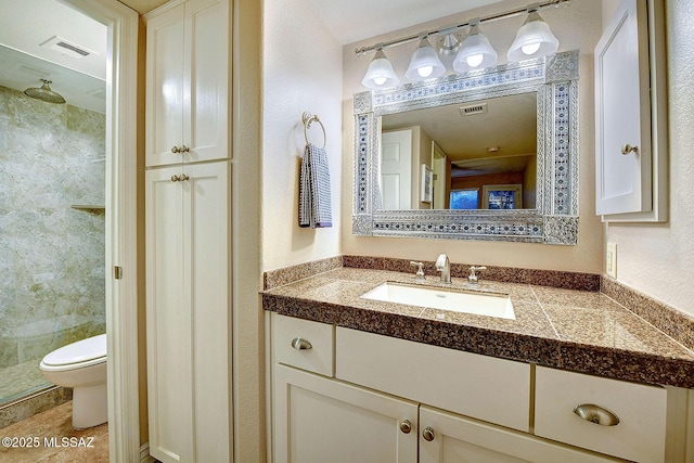 bathroom with vanity, toilet, and a shower with door