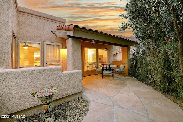 view of patio terrace at dusk