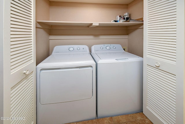 laundry area with washing machine and dryer and tile patterned floors