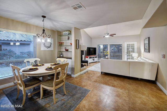 dining room featuring tile patterned floors, lofted ceiling, and ceiling fan with notable chandelier