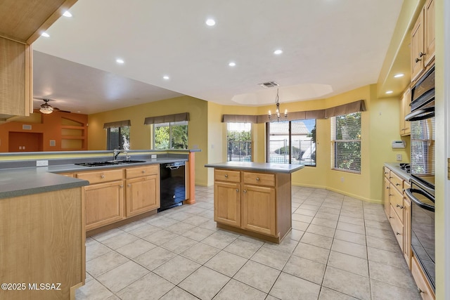 kitchen featuring hanging light fixtures, light brown cabinetry, a kitchen island, black appliances, and ceiling fan with notable chandelier