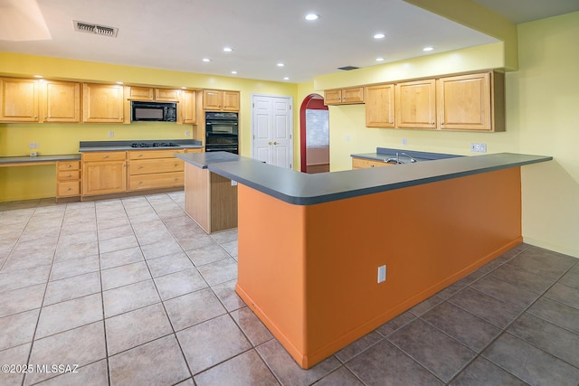 kitchen with light brown cabinets, black appliances, sink, tile patterned flooring, and a kitchen island