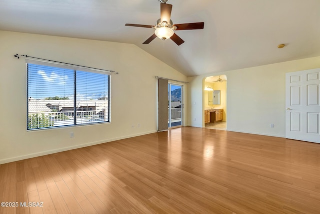 unfurnished living room with ceiling fan, light wood-type flooring, and vaulted ceiling