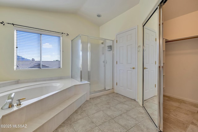 bathroom featuring tile patterned flooring, lofted ceiling, and shower with separate bathtub